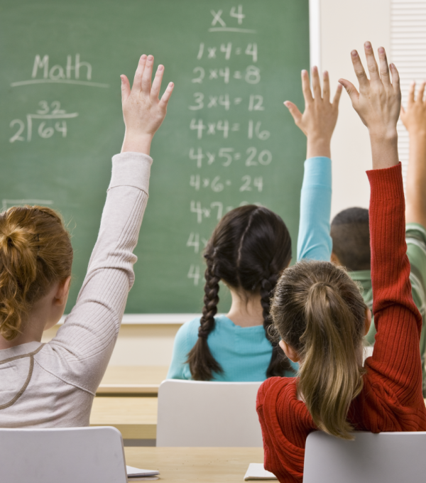 students with raised hands