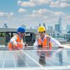 Solar panel technician on roof